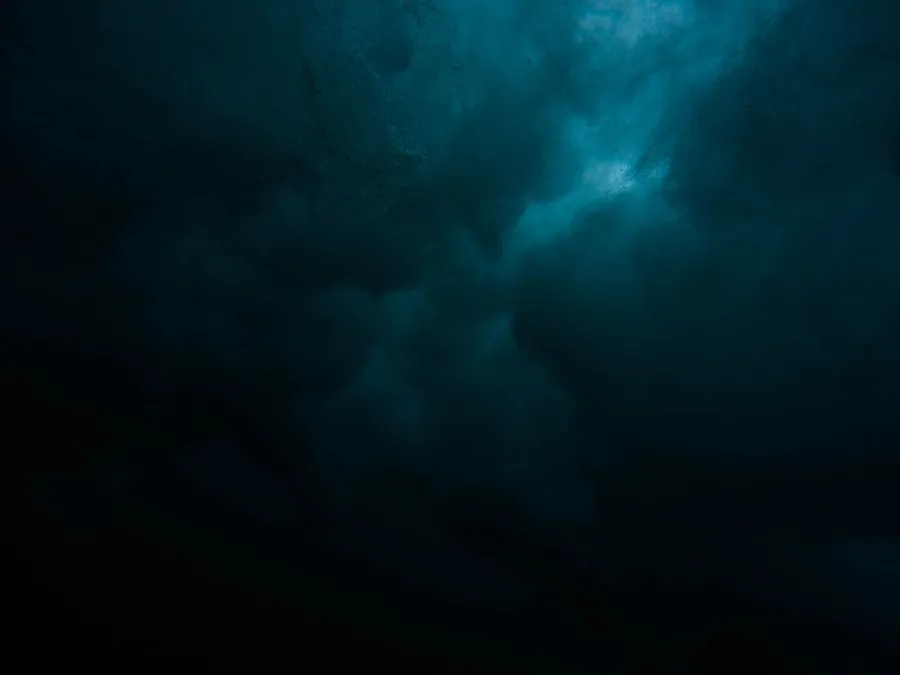 Ilustrasi mimpi iblis — a large body of water under a cloudy sky