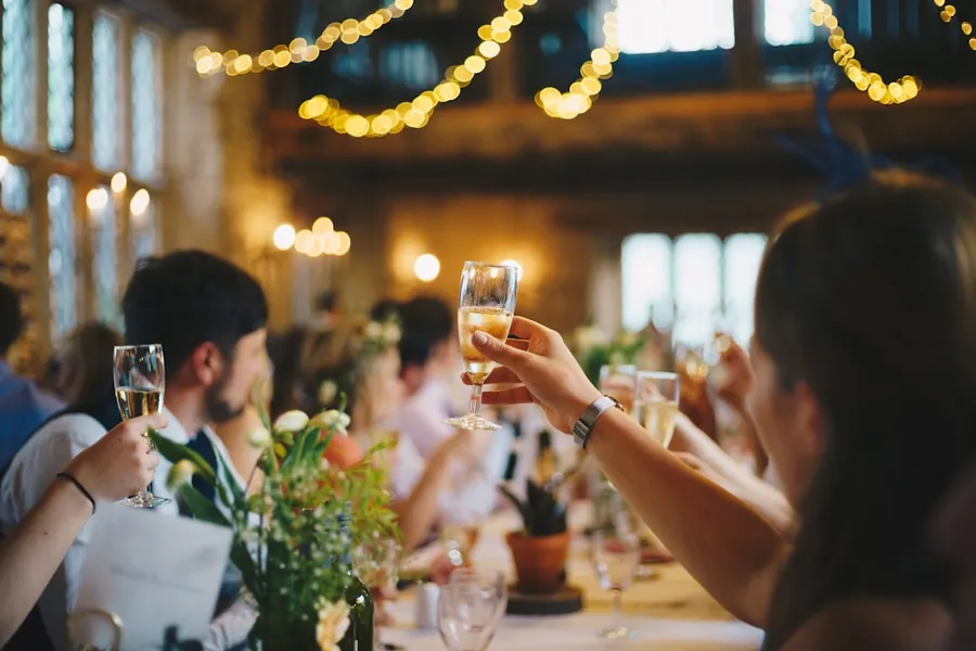 Ilustrasi mimpi pernikahan — people raising wine glass in selective focus photography